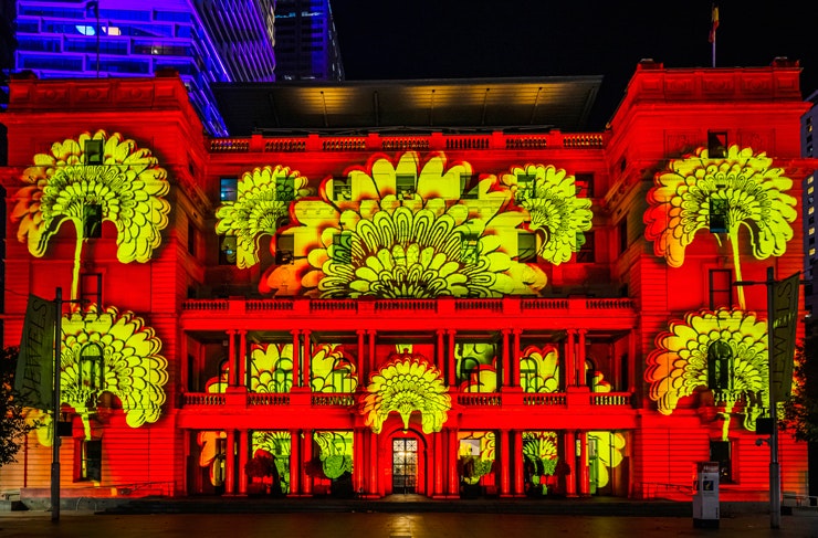 A bright red and yellow projection onto Customs House for Vivid Sydney.